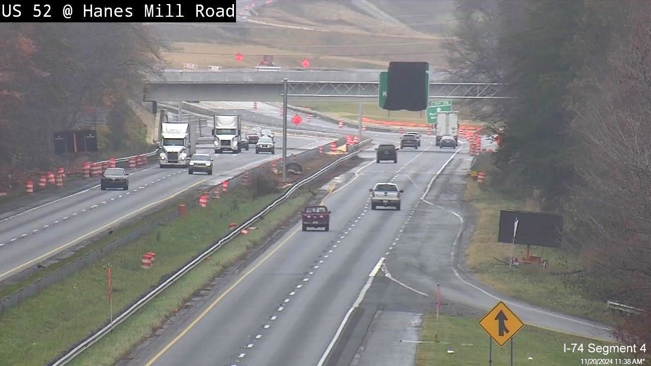 Image from traffic camera at Hanes Mill Road of new covered overhead sign on US 52 North 
        approaching the NC 74/Beltway exit, NCDOT, November 2024