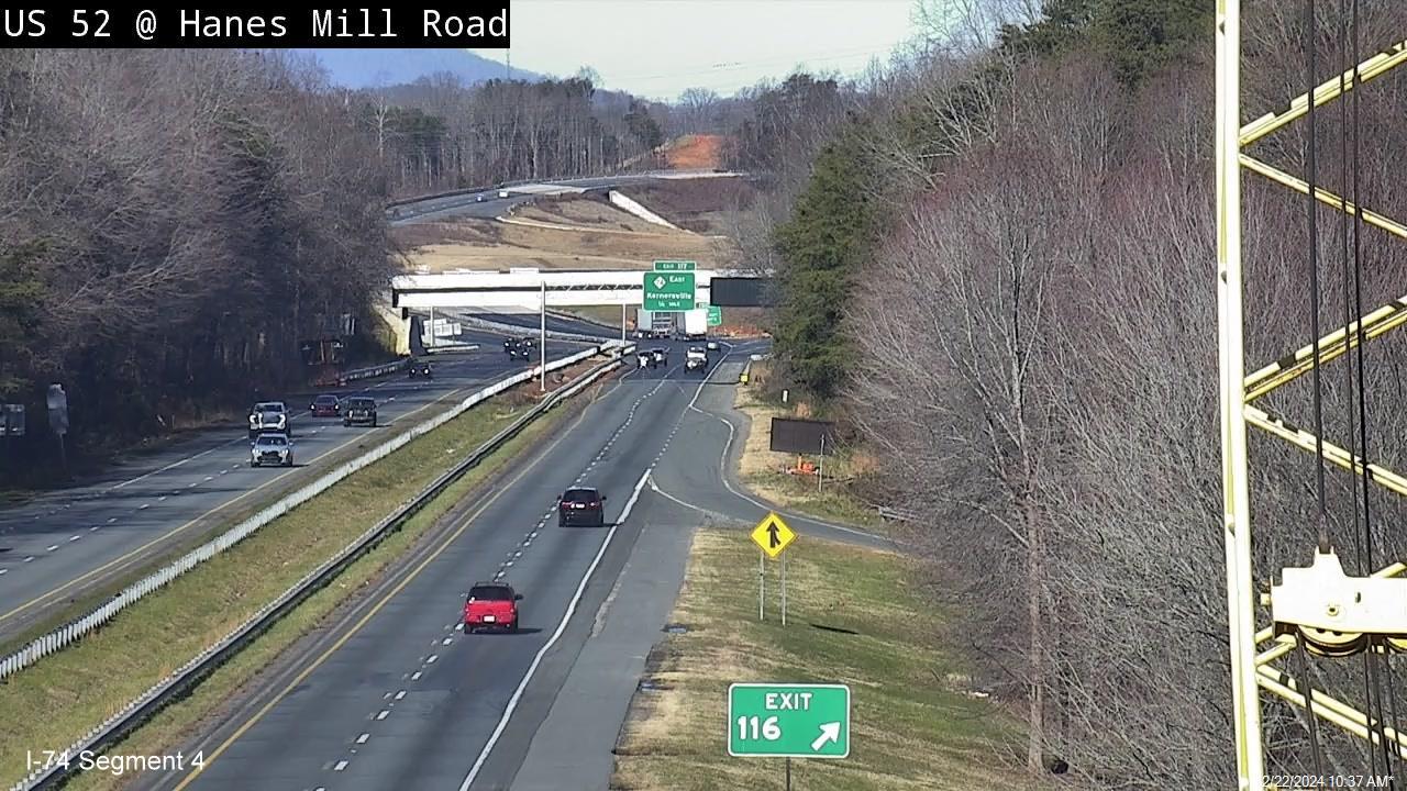 NCDOT traffic camera image from Hanes Mill Road showing uncovered NC 74 
      (Future I-74) East exit sign, December 2024