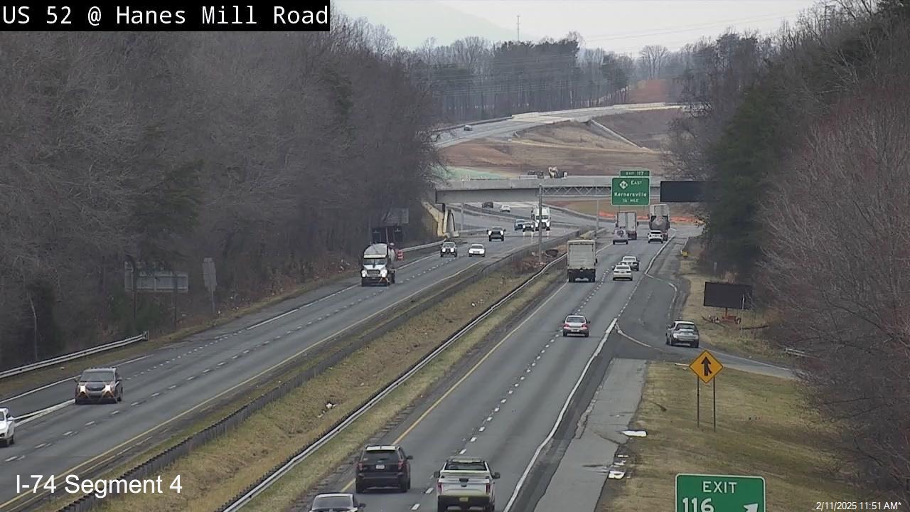 NCDOT traffic camera image from Hanes Mill Road showing uncovered NC 74 
      (Future I-74) East exit sign, December 2024