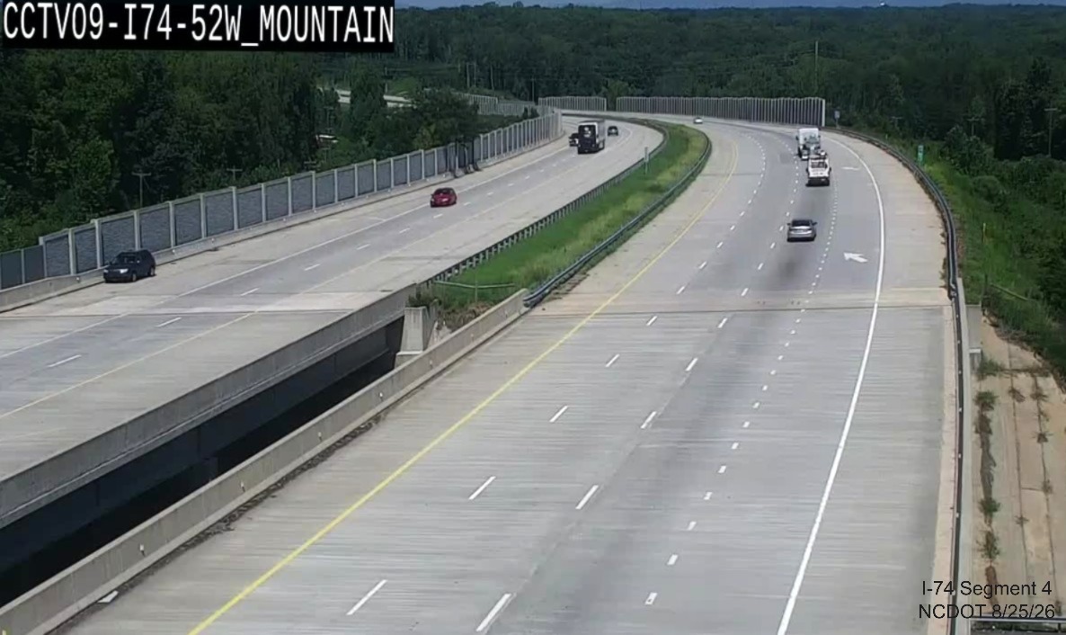 NCDOT traffic camera image at the West Mountain Street bridge looking west showing a
	 new I-74 Mile Marker and the West I-74 reassurance marker seen below, August 21, 2026