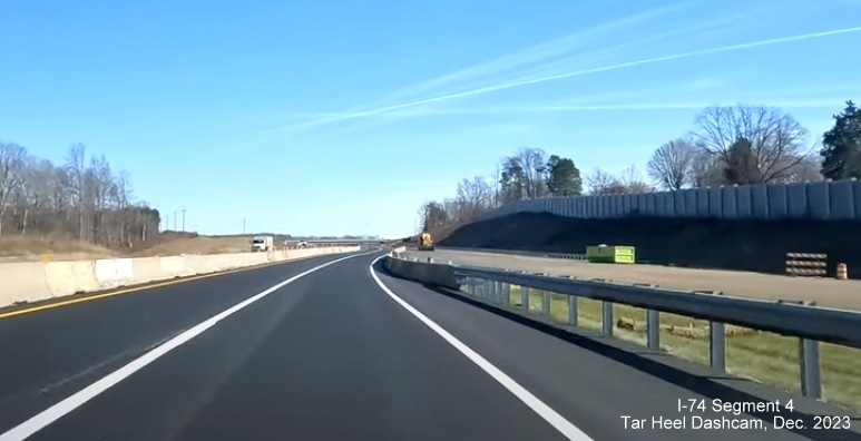 Image of NC 74 (Future I-74) East traffic shifting over to completed eastbound lanes prior to NC 66 
        exit, from video by Tar Heel Dashcam, December 2023
