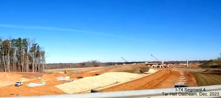 Image of future I-40 interchange with I-74/Winston-Salem Northern Beltway looking south from 
        Glen Hi Road, from video by Tar Heel Dashcam, December 2023