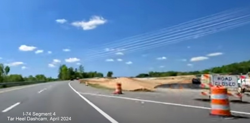 Image of closeup of future ramp to I-274 West/Winston-Salem Northern Beltway showing paving occuring, 
        screen grab from Tar Heel Dashcam video, April 2024