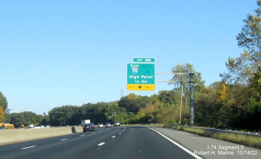 Image of 1/2 mile advance overhead sign for I-74 East exit on I-40 East in Winston-Salem with 
        dropped South US 311 information, October 2022