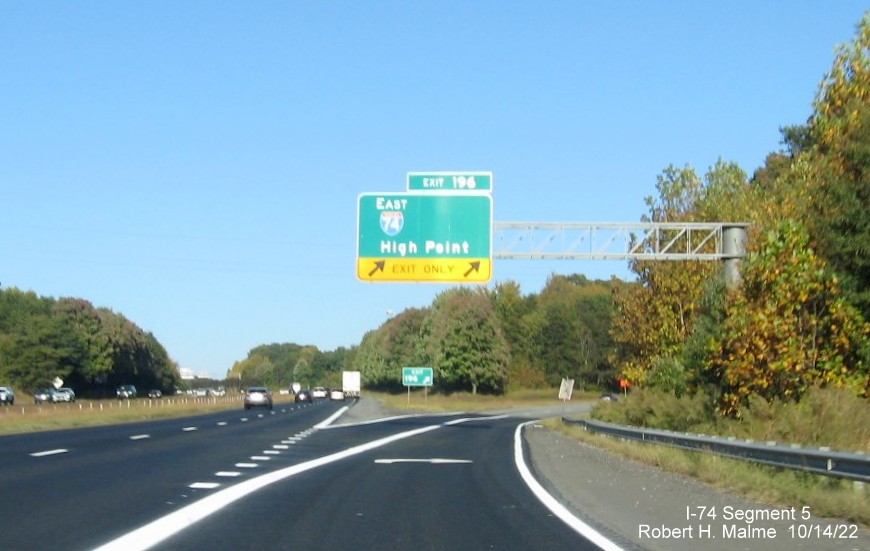 Image of overhead ramp sign for I-74 East exit on I-40 East in Winston-Salem with 
        dropped South US 311 information, October 2022