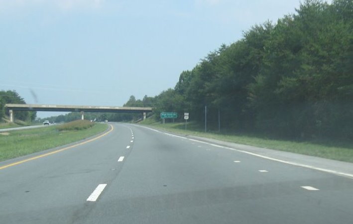 Photo of sign posts being installed along US 311 for Future I-74 sign