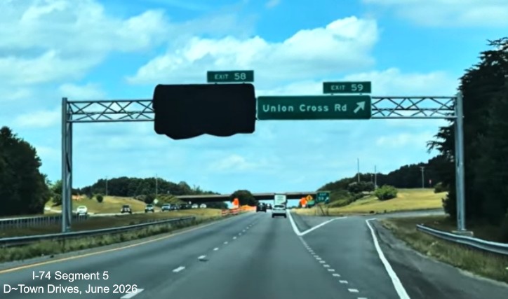 Image of overhead signage at Union Cross Road exit on I-74 West, exit sign for
	  future NC 192 exit at Beltway is covered over, D~Town Drives, June 2026