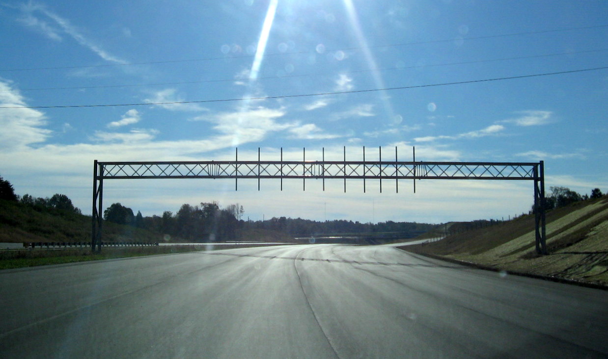 Photo of sign gantry still awaiting exit signs at I-85 interchange in 
Oct. 2010