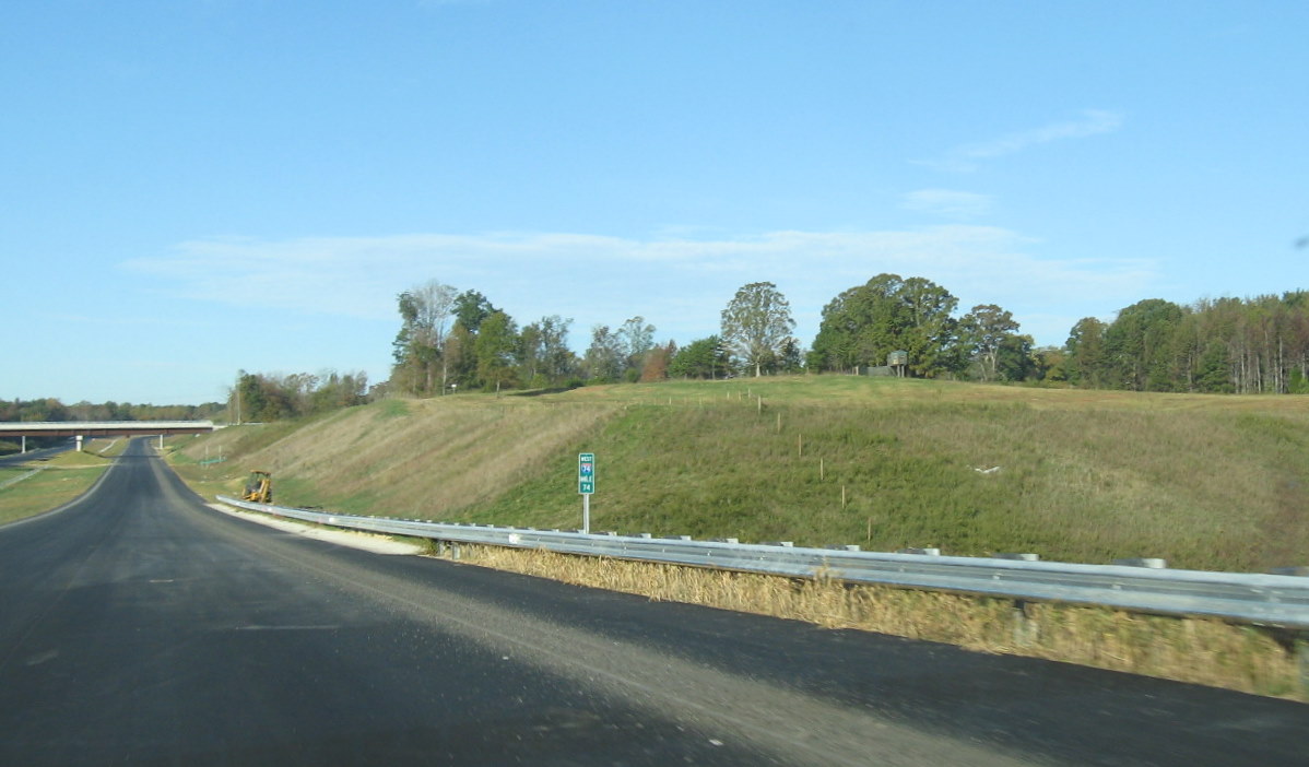 Photo of I-74 West mile marker along unopened roadway in Oct. 2010