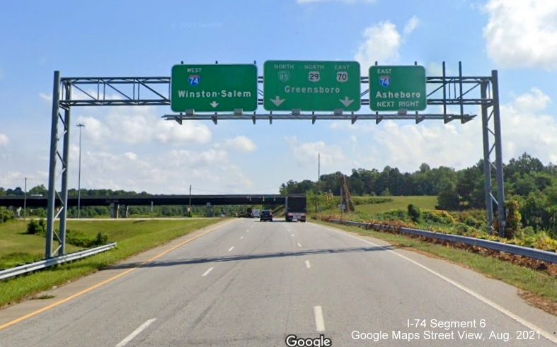 Overhead signage at Business 85 North interchange with I-74 with blank space for former US 311 
        signs, Google Maps Street View image, August 2021