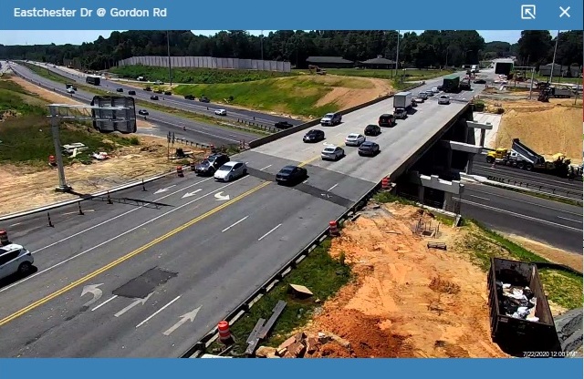 NCDOT traffic camera image showing installation of future overhead ramp guide signs for new ramps
                                                 to I-74 from Eastchester Drive, July 2020