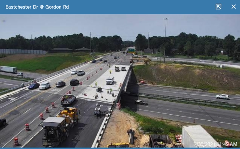 NCDOT traffic camera image showing final paving of new westbound section 
      of future US 70 bridge over I-74 in High Point, July 2021