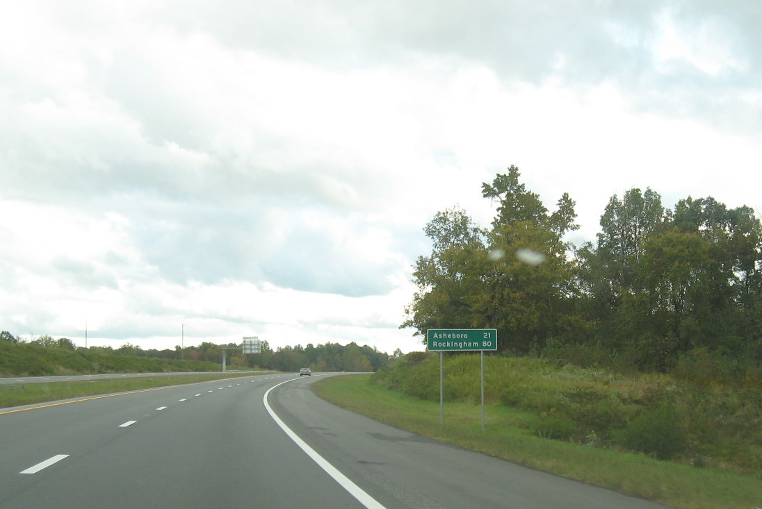 Photo of mileage sign on new portion of I-74 East freeway beyond I-85 exit 
south of High Point in October 2011