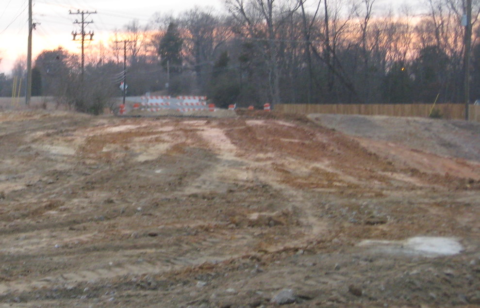 Photo showing progress removing previous alignment of Cedar Square Rd needed 
to construct new I-74 exit ramps