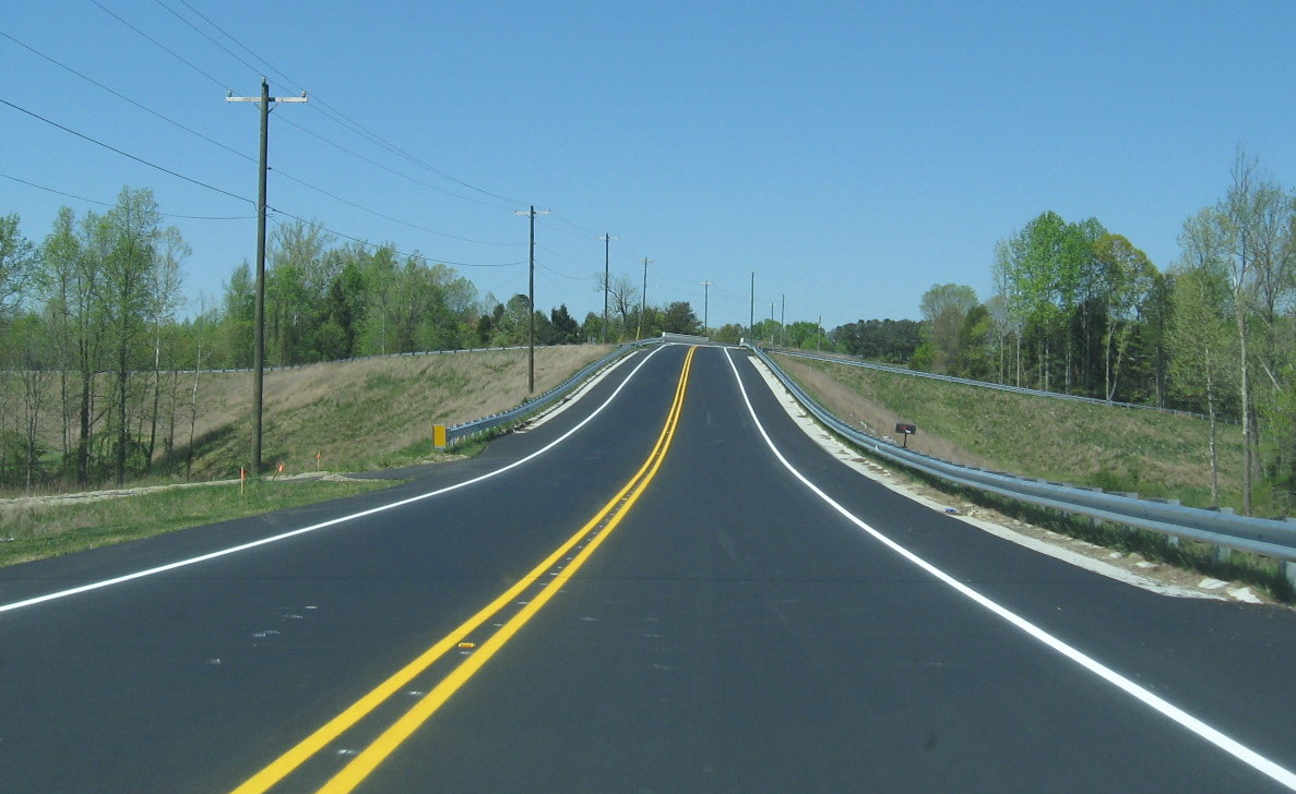 Photo showing work completed on open Tuttle Road Bridge and reconstructed
road in area, April 2010