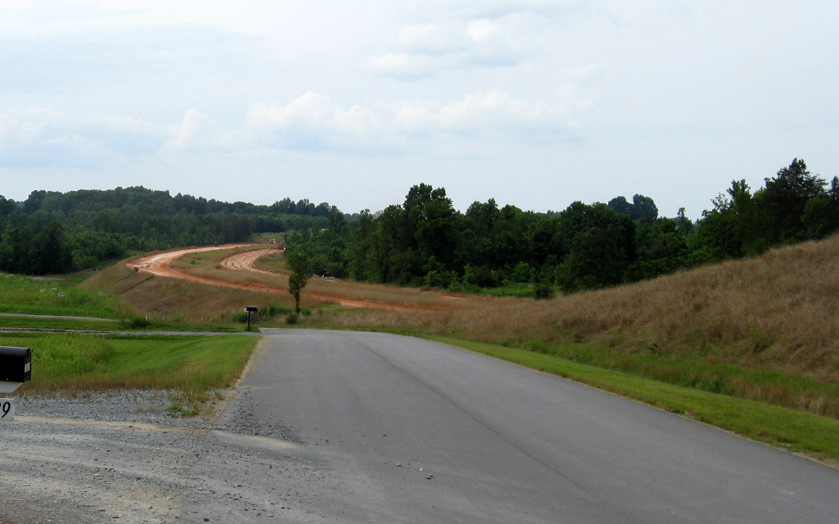 Photo of view north of Plainfield Rd Bridge showing progress in grading the 
future I-74 freeway roadbed in June 2012
