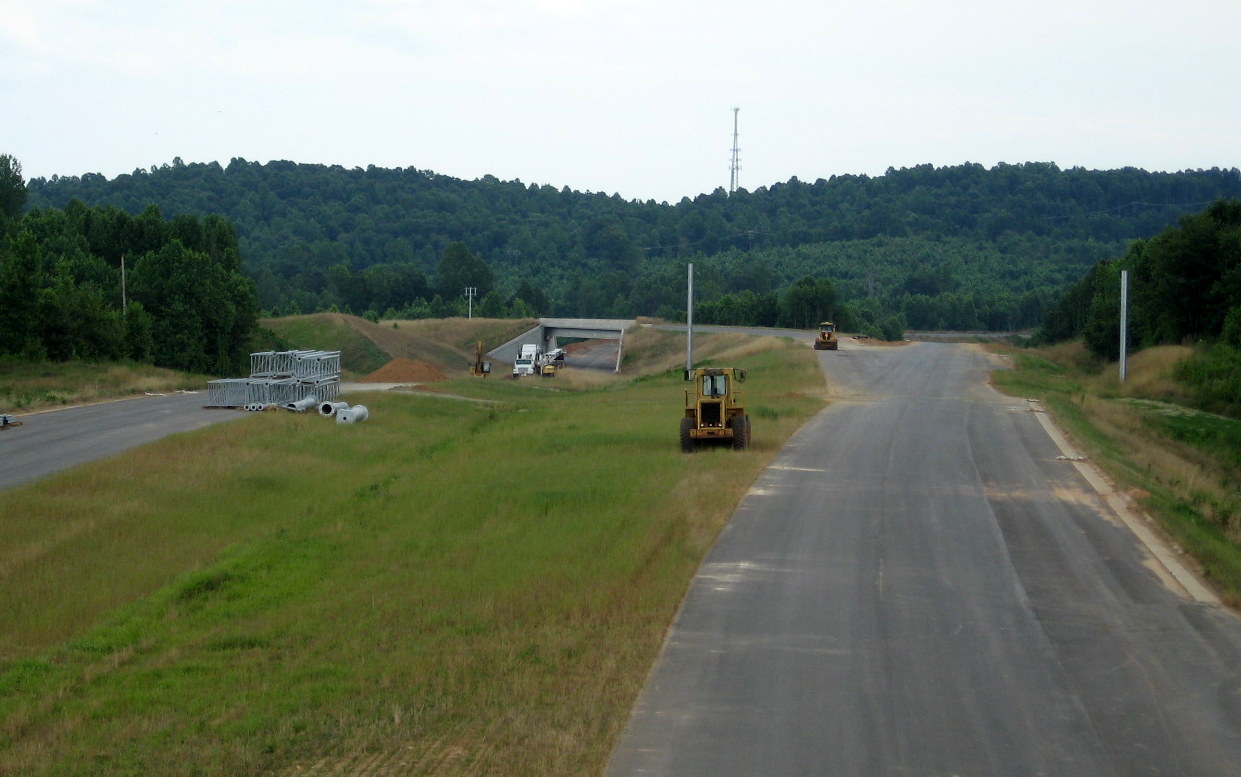 Photo of view south of Heath Dairy Road Bridge showing start of overhead sign 
installation for US 220 interchange on future I-74 freeway near Randleman, June 2012
