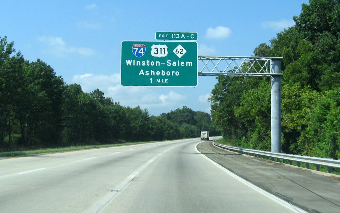 Photo showing I-85 overhead exit signs for the unopened I-74 interchange in 
Oct. 2010