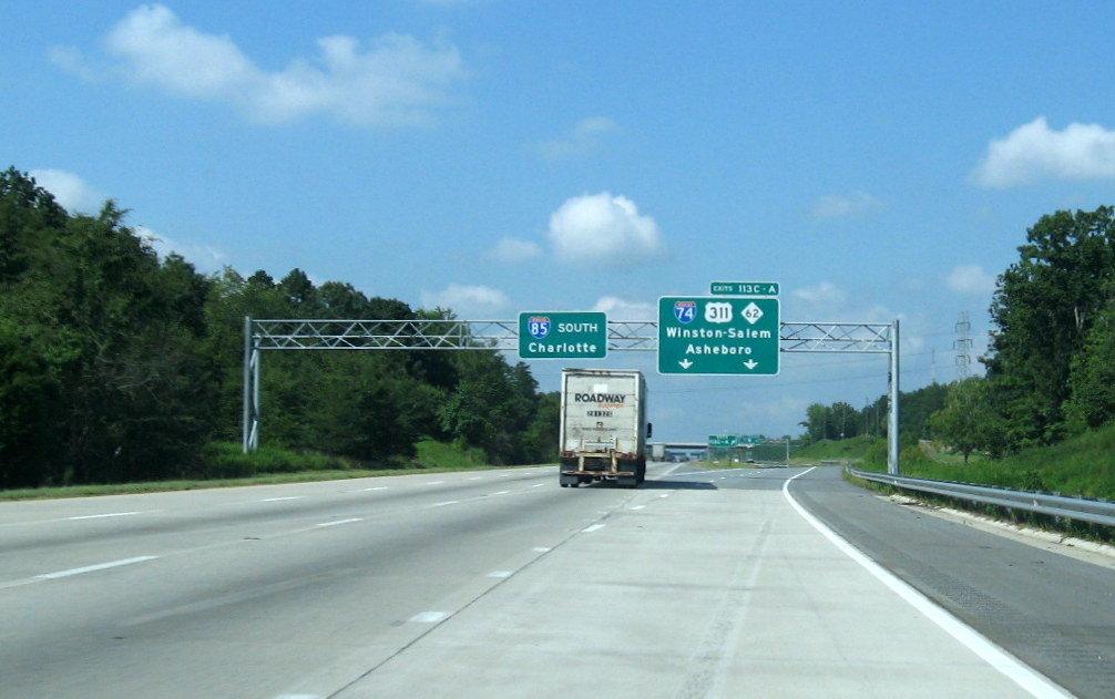 Photo of overhead signage for I-74/US 311 interchange at ramp to C/D lanes on 
I-85 South, Aug. 2012
