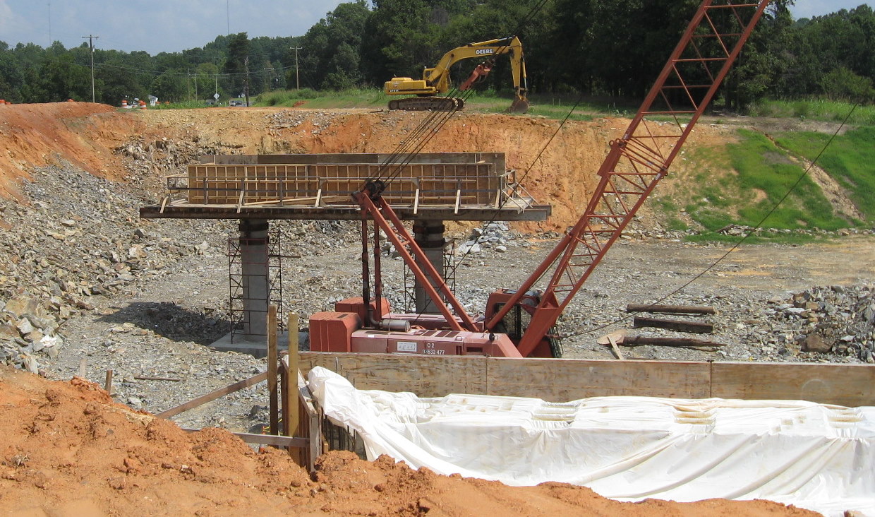 Photo showing progress building center supports for Plainfield Rd Bridge 
over the future I-74 freeway in Aug. 2010
