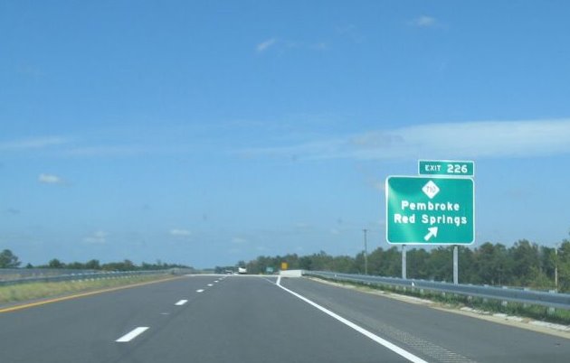 Photo of exit signage for NC 710 on I-74/US 74 freeway showing old (wrong) 
exit number in Oct. 2008