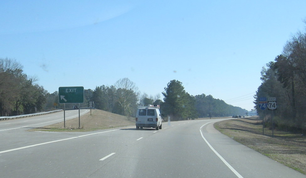 Photo of exit sign for US 74 Business with greened out duplicative exit 
number, Feb. 2009