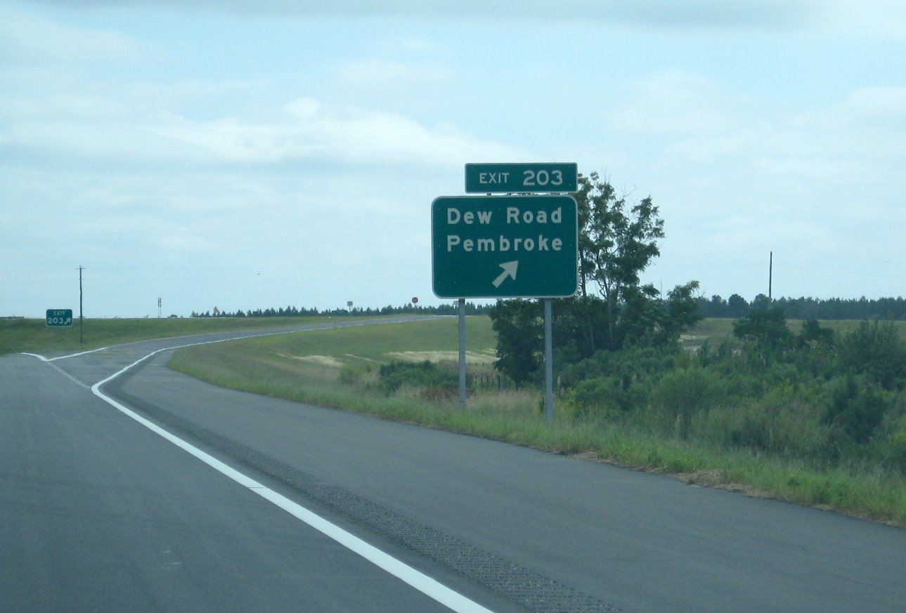 Photo of Dew Road exit sign showing revised exit number changed from contract 
documents in 2007