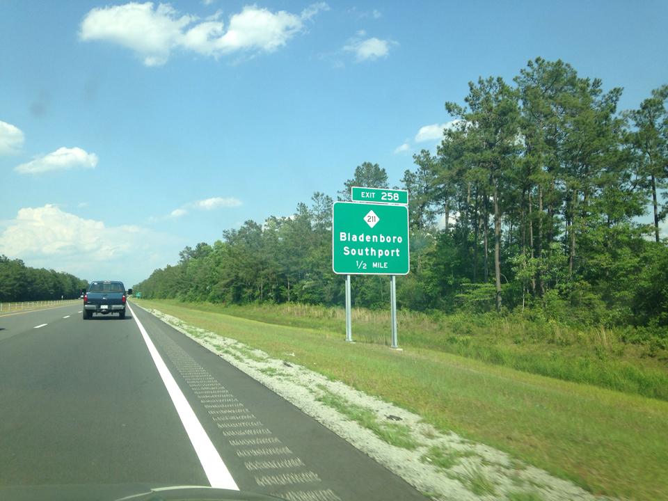 image of NC 211 exit sign with I-74 mileage on US 74/76, photo by Chris Curley