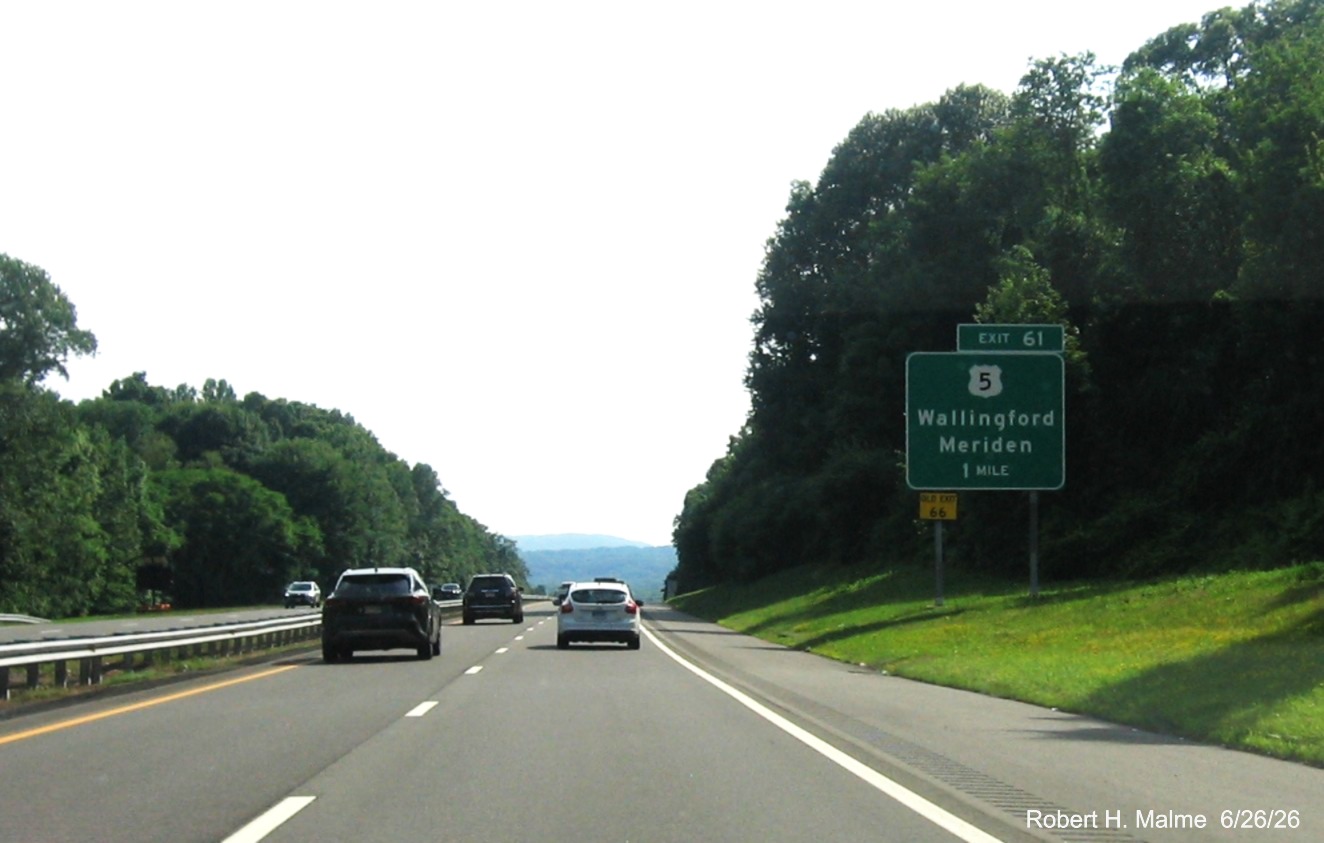 Image of new ground mounted 1 Mile advance sign for the US 5 exit, with yellow Old Exit 66 sign 
 on support post on CT 15 South/Cross Parkway in Wallingford, June 2026