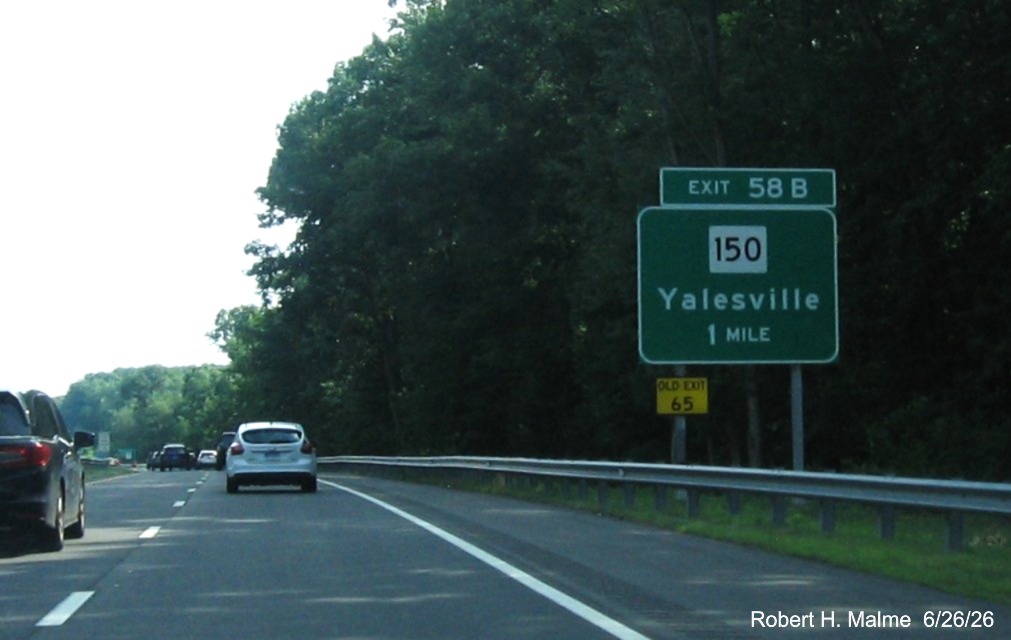 Image of new ground mounted 1 Mile advance sign for the CT 150 exit, with
 Old Exit 65 sign on CT 15 South/Cross Parkway in Wallingford, by Jay Hogan, January 2026