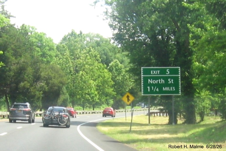 Image of 1 1/4 miles advance sign for the North Street exit, with new milepost based exit
 number on CT 15 North/Merritt Parkway in Greenwich