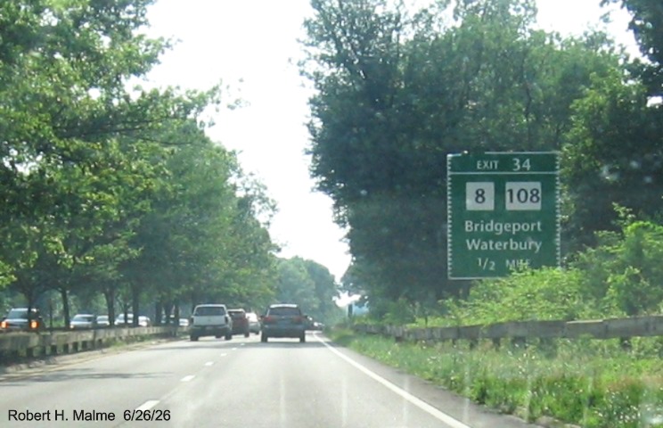 Image of ground mounted 1/2 Mile advance sign for the CT 8/108 exit, with new milepost 
 based exit number on CT 15 South/Merritt Parkway in Trumbull, June 2026