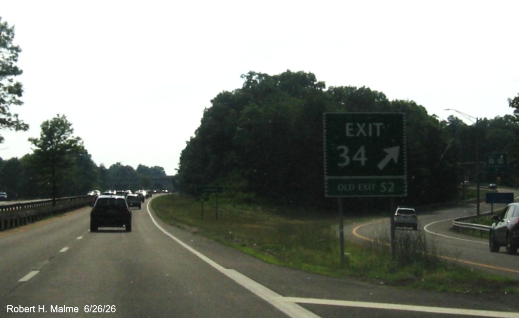 Image of gore sign for the CT 8/108 exit, with new milepost based exit number and Old Exit 
 52 sign on support post on CT 15 South/Merritt Parkway in Trumbull, June 2026