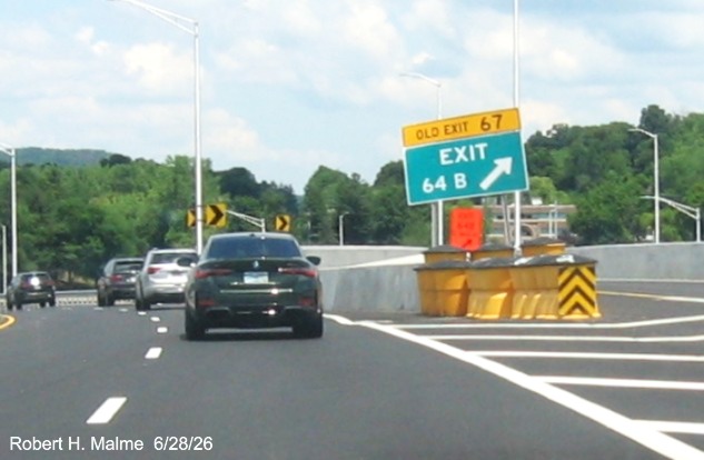 Image of gore sign for the East Main Street exit, with new milepost based exit number  
 overlay on exit tab on CT 15 North/Cross Parkway in Meriden, June 2026