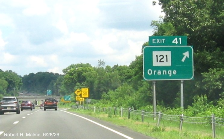Image of ground mounted ramp sign for the CT 121 exit, with new milepost based exit 
 number on CT 15 North/Cross Parkway in Orange, by Jay Hogan, October 2025
