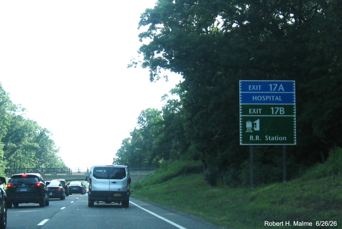 Image of blue and green auxiliary sign for the To US 7 North exit, now with new milepost based 
 exit number on CT 15 South/Merritt Parkway in Norwalk