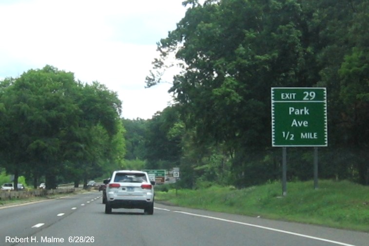 Image of ground mounted 1/2 mile advance sign for the Park avenue exit, with new milepost 
 based exit number on CT 15 North/Merritt Parkway in Fairfield, June 2026