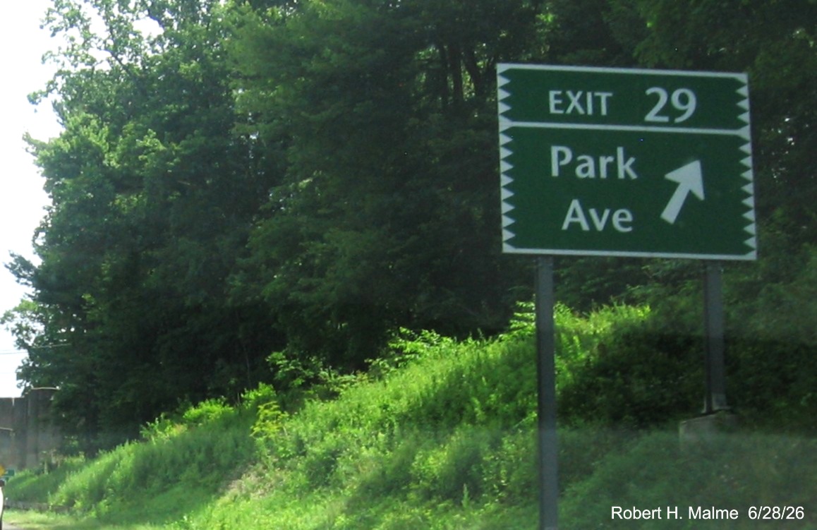 Image of ground mounted ramp sign for the Park Avenue exit, with new milepost based exit 
 number and Old Exit 47 sign on support post on CT 15 North/Merritt Parkway in Fairfield, June 2026