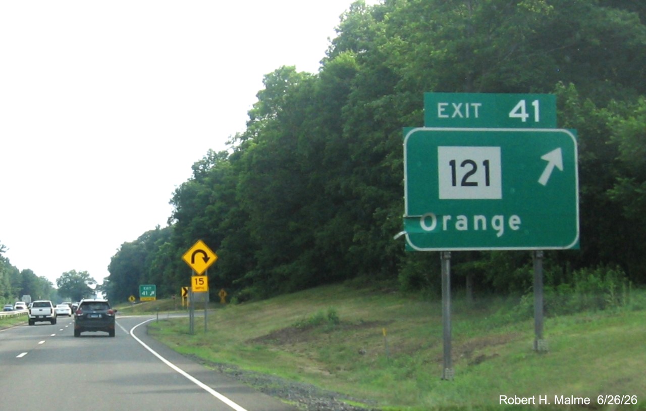 Image of ground mounted exit sign for the CT 121 exit, with new milepost based exit number 
 on CT 15 South/Cross Parkway in Orange, June 2026