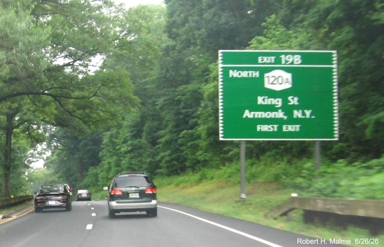 Image of 1 mile advance sign for North NY 120A exit, with new NY milepost based number on 
 CT 15 South/Merritt Parkway in Greenwich
