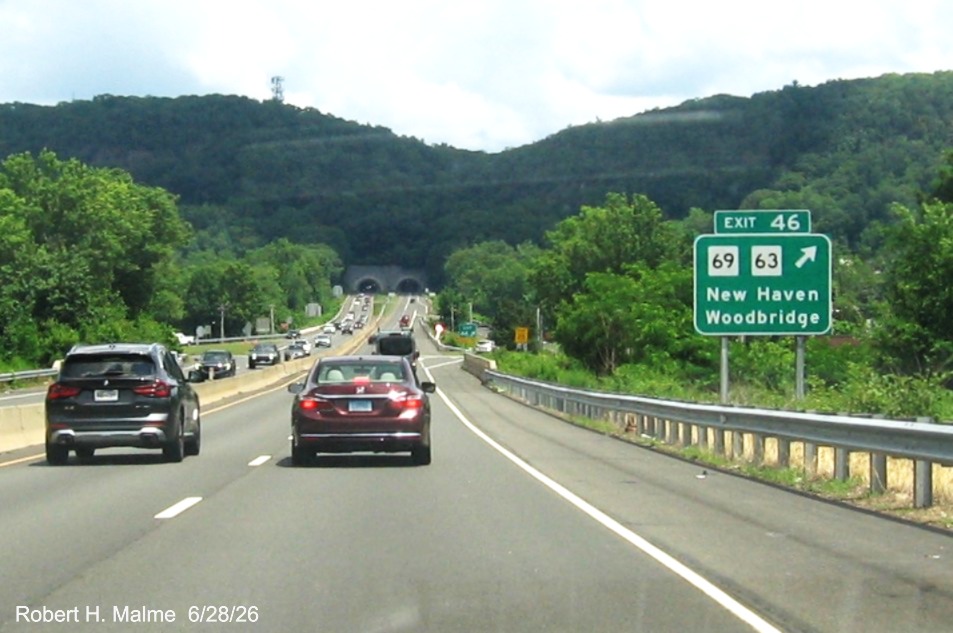 Image of ground mounted ramp sign for the CT 69/63 exit, with new milepost 
 based exit numbers on CT 15 North/Cross Parkway in Woodridge, June 2026