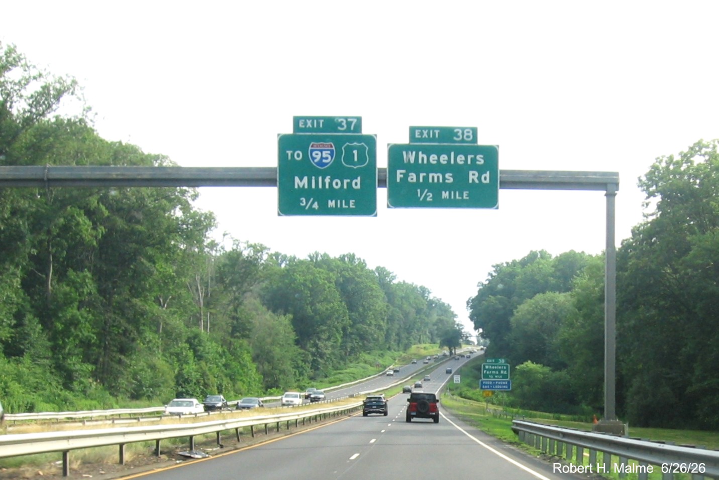 Image of 3/4 Mile advance sign for the Yo I-95/US 1 exit and the 1/2 mile advance overhead 
 sign for the Wheelers Farm Road exit, with new milepost based exit number on CT 15 South/Cross Parkway in Milford, June 2026