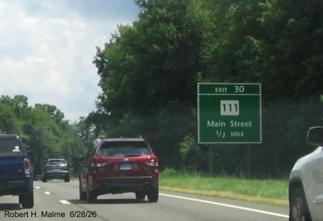 Image of 1/2 Mile advance sign for the CT 111/Main Street exit, with new milepost based exit 
 number and Old Exit 48 sign on support post on CT 15 North/Merritt Parkway in Bridgeport, June 2026