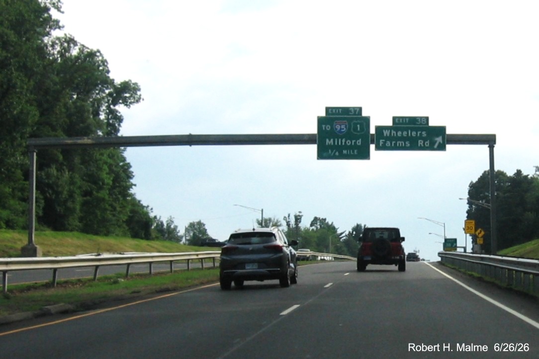 Image of 1/4 mile advance overhead sign for the To I-95/US 1 exit, with new milepost 
 based exit number and Old Exit 53 sign on support post on CT 15 South/Cross Parkway in Milford, June 2026