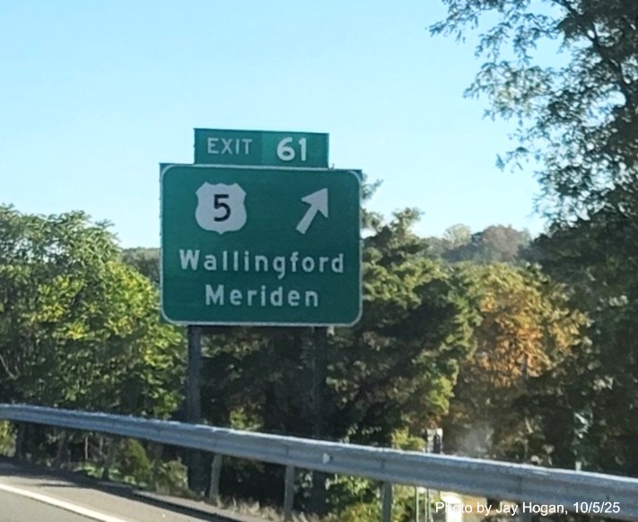 Image of ground mounted 1 Mile advance sign for the US 5 exit, with
 new milepost based exit number overlay on exit tab and yellow Old Exit 66 sign on support post on CT 15 North/Cross Parkway 
 in Wallingford, by Jay Hogan, August 2025