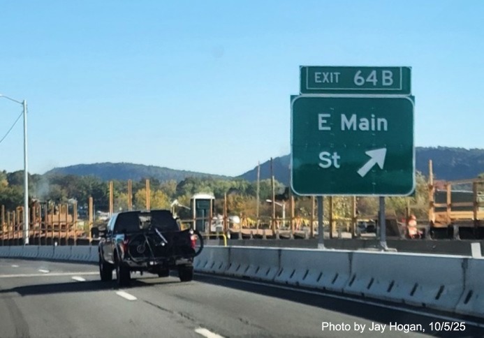 Image of ground mounted exit sign for the East Main Street exit, with
 new milepost based exit number overlay on exit tab on CT 15 North/Cross Parkway in Meriden, by Jay Hogan, August 2025