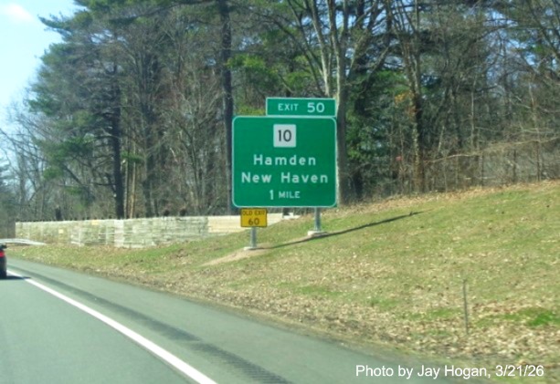 Image of new 1 mile advance ground mounted sign for the CT 10 exit, with 
 new milepost based exit number with yellow Old Exit 60 sign on support post on CT 15 South/Cross Parkway in Hamden, 
 by Jay Hogan, March 2026