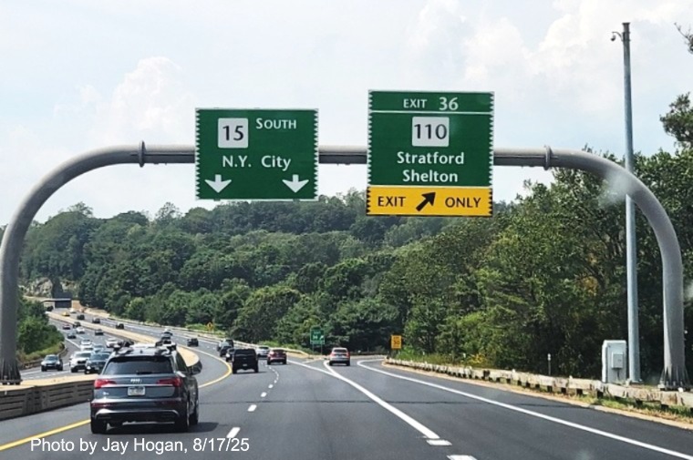 Image of 1 mile advance overhead sign for the CT 110 exit, with new milepost based exit 
 number and Old Exit 53 sign on support post on CT 15 South/Merritt Parkway in Stratford, by Jay Hogan, August 2025