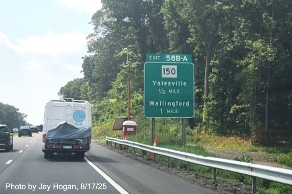 Image of ground mounted 1 Mile advance sign for the CT 150 exits, with
 new milepost based exit number overlays on exit tab on CT 15 South/Cross Parkway in Wallingford, 
 by Jay Hogan, August 2025