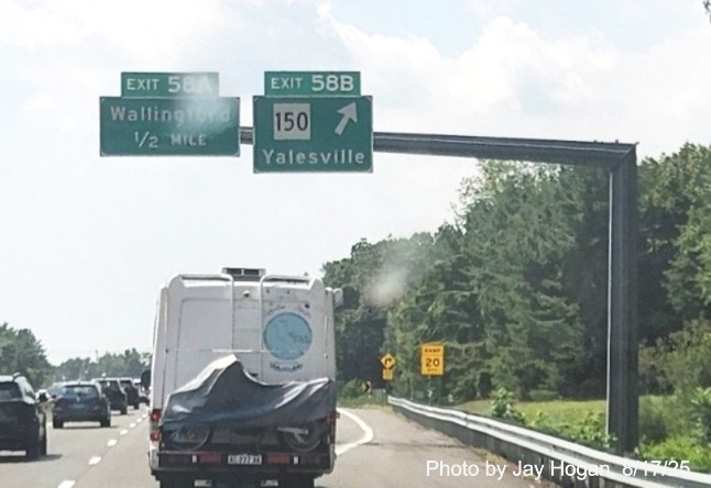 Image of overhead signage at ramp for CT 150, with
 new milepost based exit number overlays on exit tabs on CT 15 South/Cross Parkway in Wallingford, 
 by Jay Hogan, August 2025